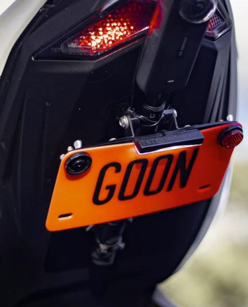 Close-up of a motorcycle with an orange license plate reading 'GOON'.
