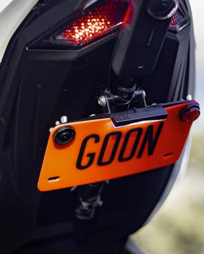 Close-up of a motorcycle with an orange license plate reading 'GOON'.