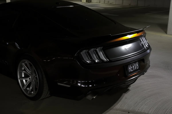 mustang with a visible custom magnetic license plate in an underground parking garage